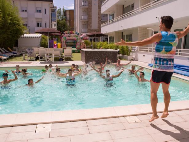 Lezione di acquagym in piscina con istruttore e partecipanti.